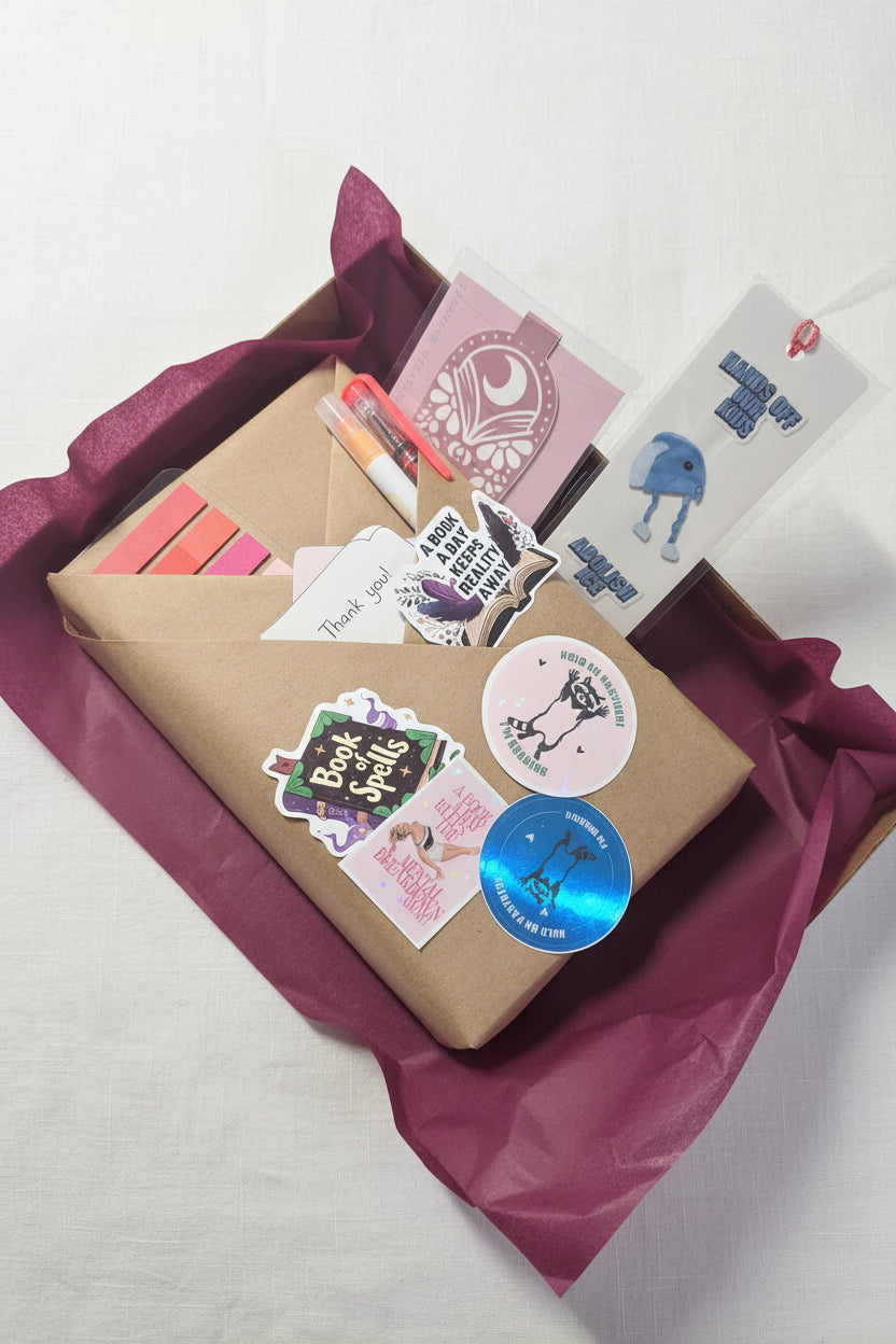 Book wrapped in brown craft paper with Stickers on a box with a visible brand logo in the background
