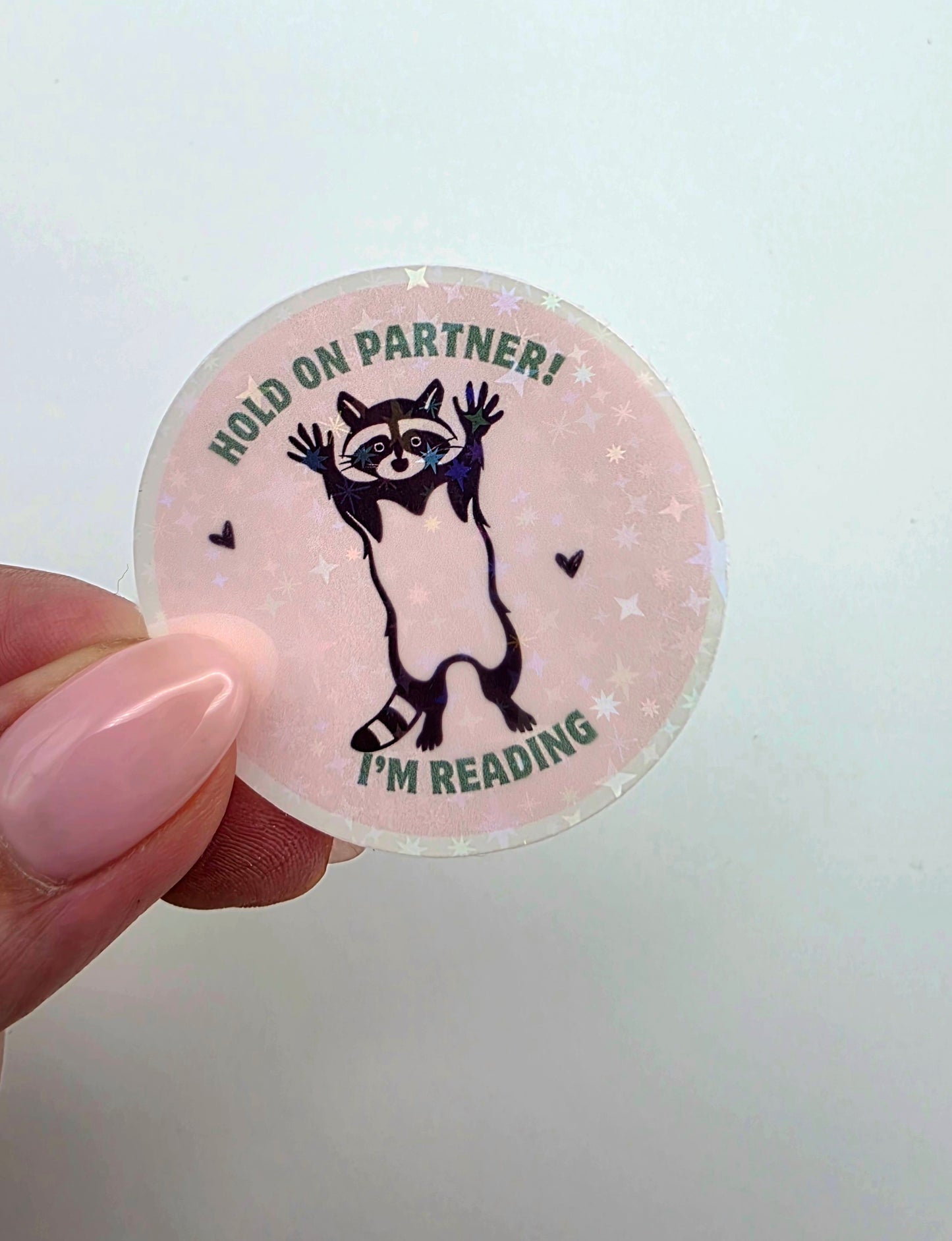 Round Vinyl Holographic Sticker: Hold On Partner Raccoon
