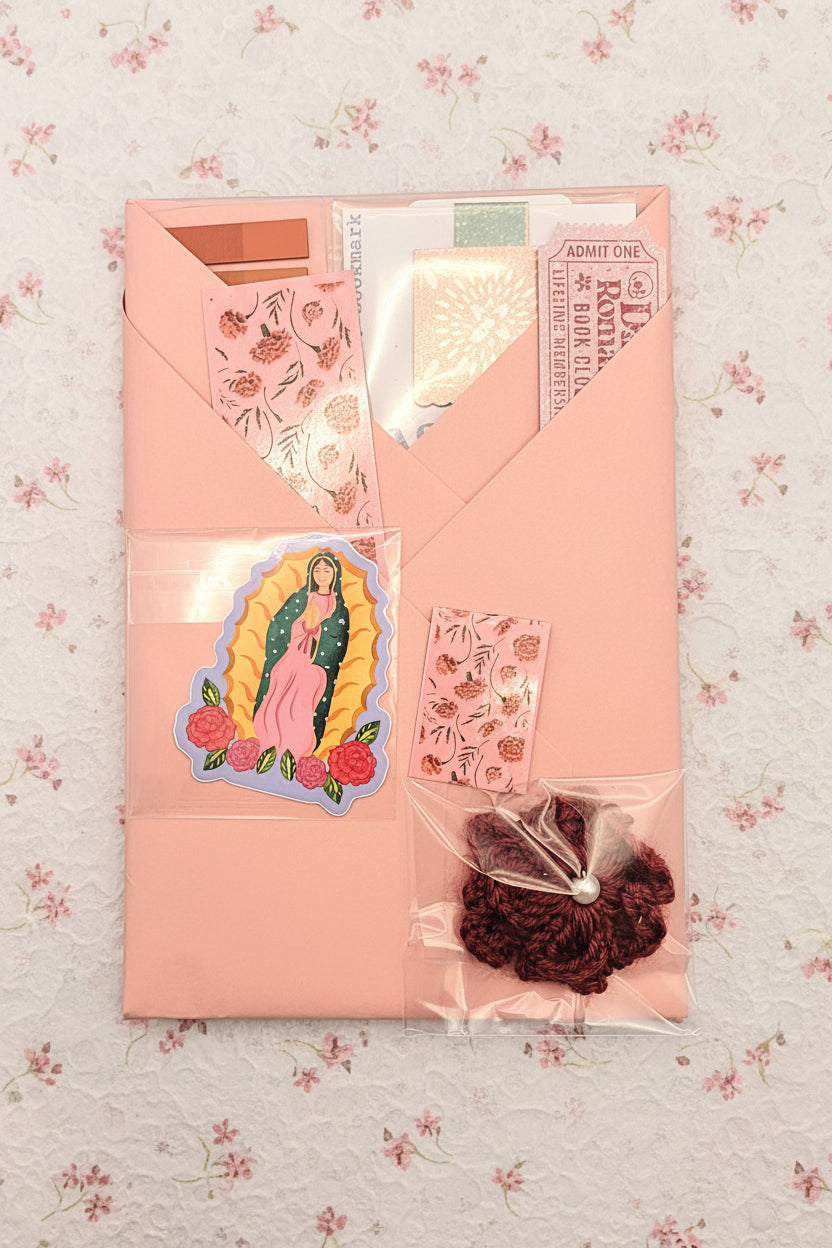 Pink card with stickers and a small bag on a blue background